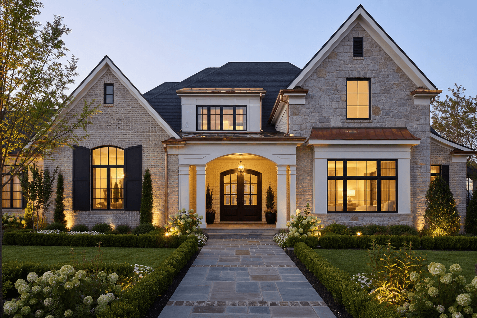 Transitional brick and stone luxury custom home with grand covered entry